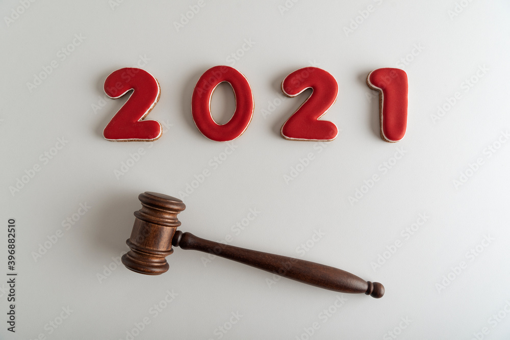 Red lettering 2021 and judges gavel or hammer on white background. Court case Red lettering 2021 and judges gavel or hammer on white background. Court case