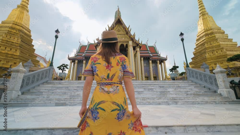 Asian woman visiting Wat Phra Kaew or Emerald buddha temple in Bangkok Thailand