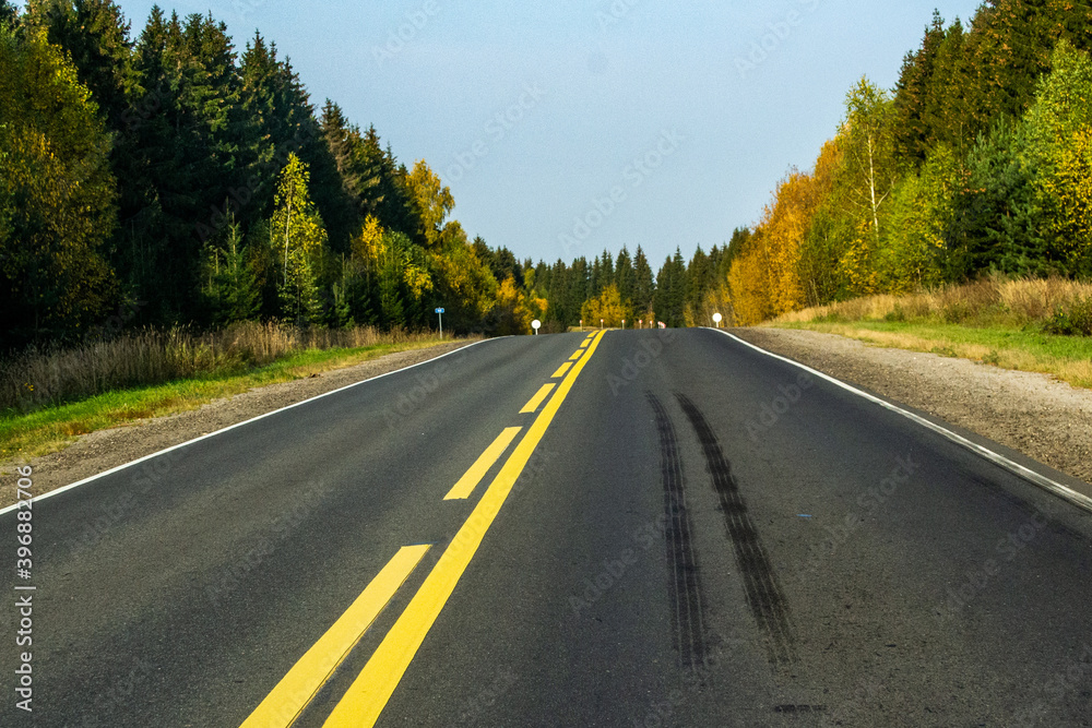 Road with yellow markings and truck wheel brake marks Road with yellow markings and truck wheel brake marks