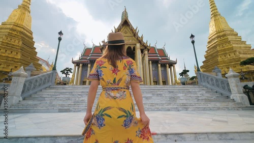 Asian woman visiting Wat Phra Kaew or Emerald buddha temple in Bangkok Thailand