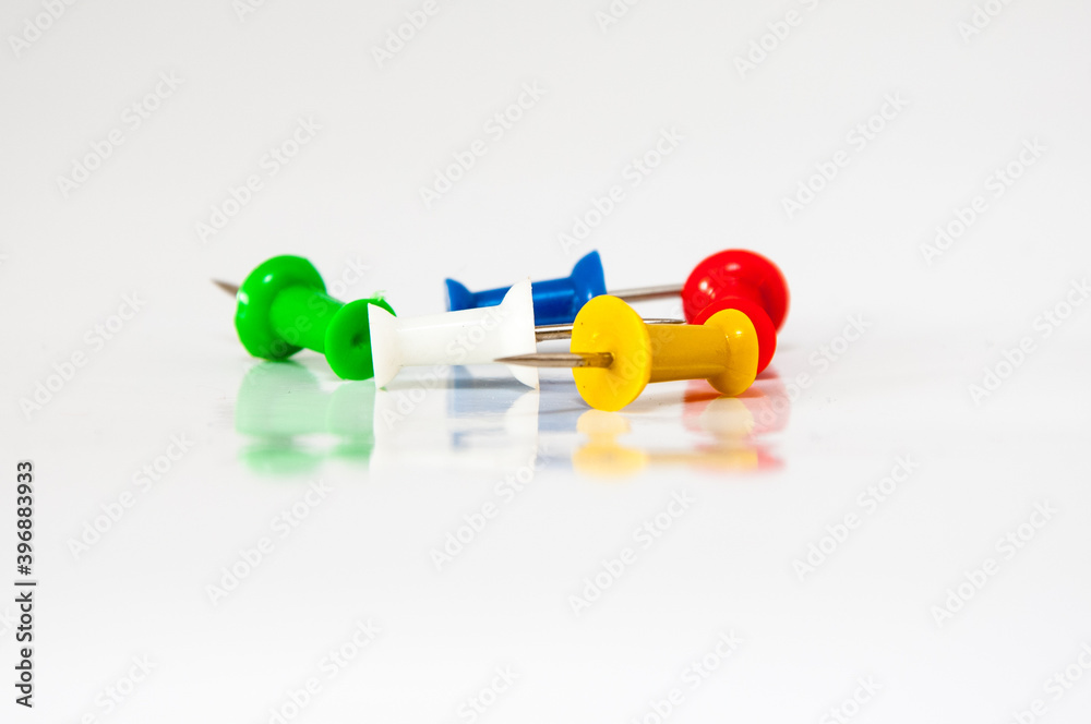 Pins in different colors, collection of various pushpins on white background Pins in different colors, collection of various pushpins on white background