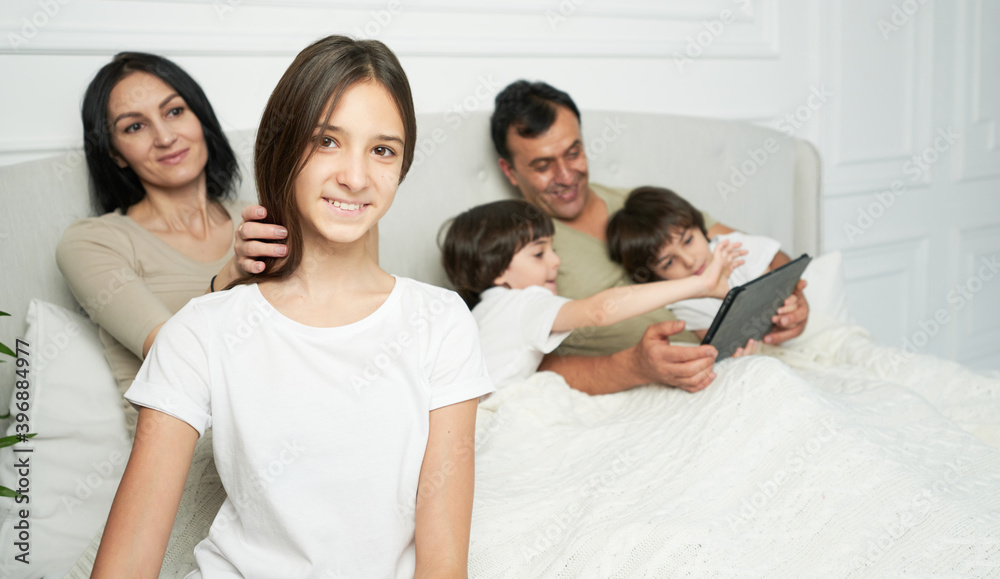 Happy daughter. Portrait of pretty teenage latin girl smiling at camera while spending time with her family in the morning Happy daughter. Portrait of pretty teenage latin girl smiling at camera while spending time with her family in the morning