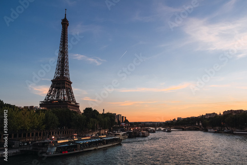 Image of the Eiffel tower against a sunset sky. Copy space. Architecture concept. © Ana