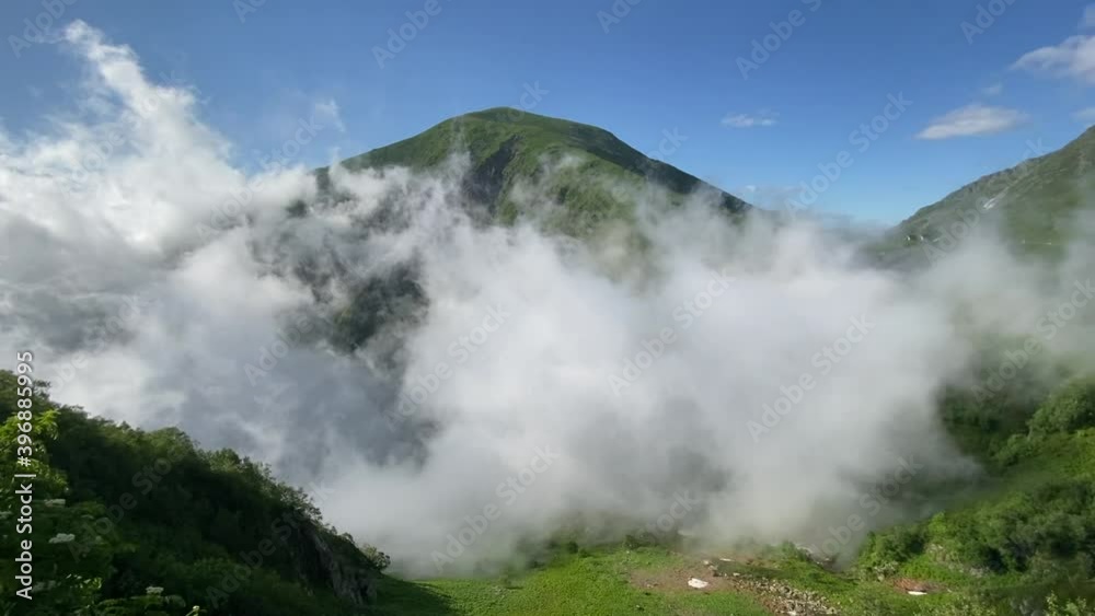 Hiking in the mountains with beautiful views of clouds and green mountains Hiking in the mountains with beautiful views of clouds and green mountains