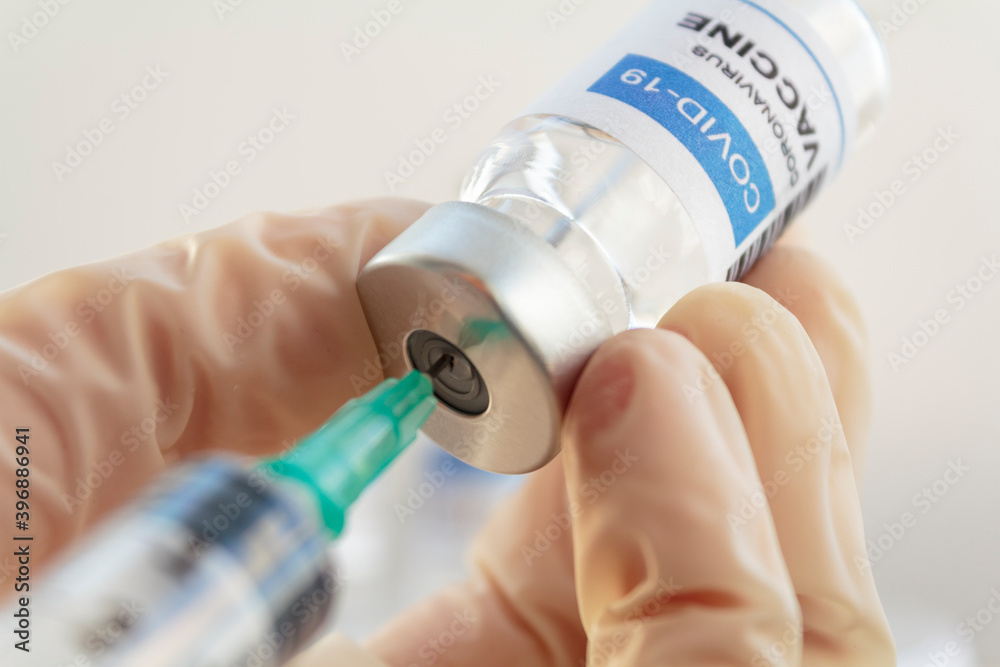 Doctor hand preparing Covid-19 Coronavirus vaccine
