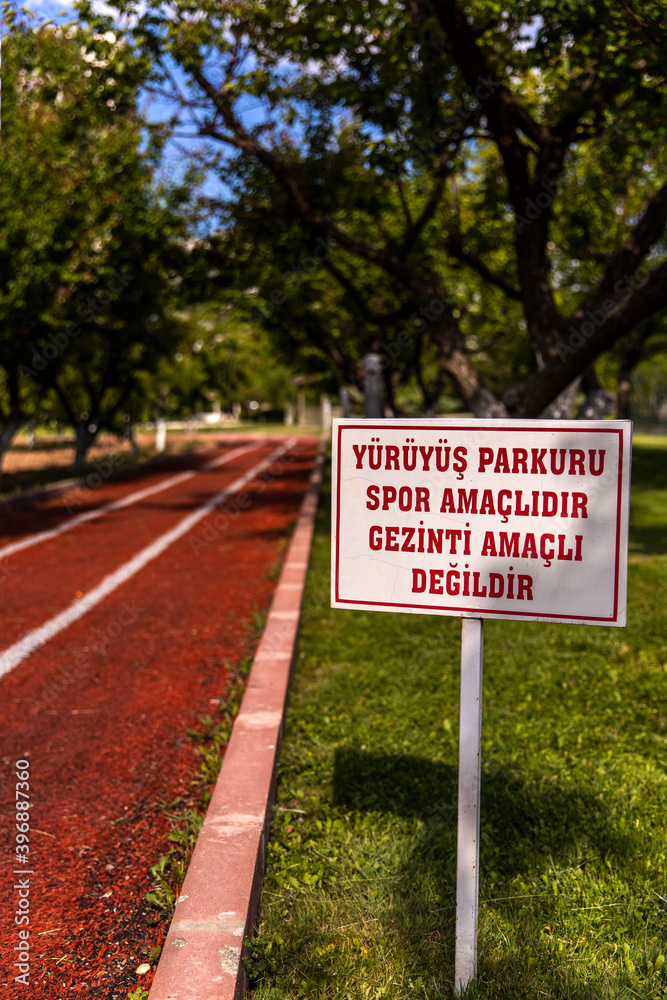 Regulatory warning sign about the walking track in public area 