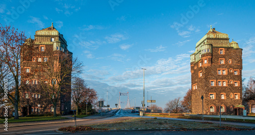 Die beiden historischen Brückentürme der Friedrich-Ebert-Brücke in Duisburg Ruhrort mit Blick auf die Rheinbrücke photo