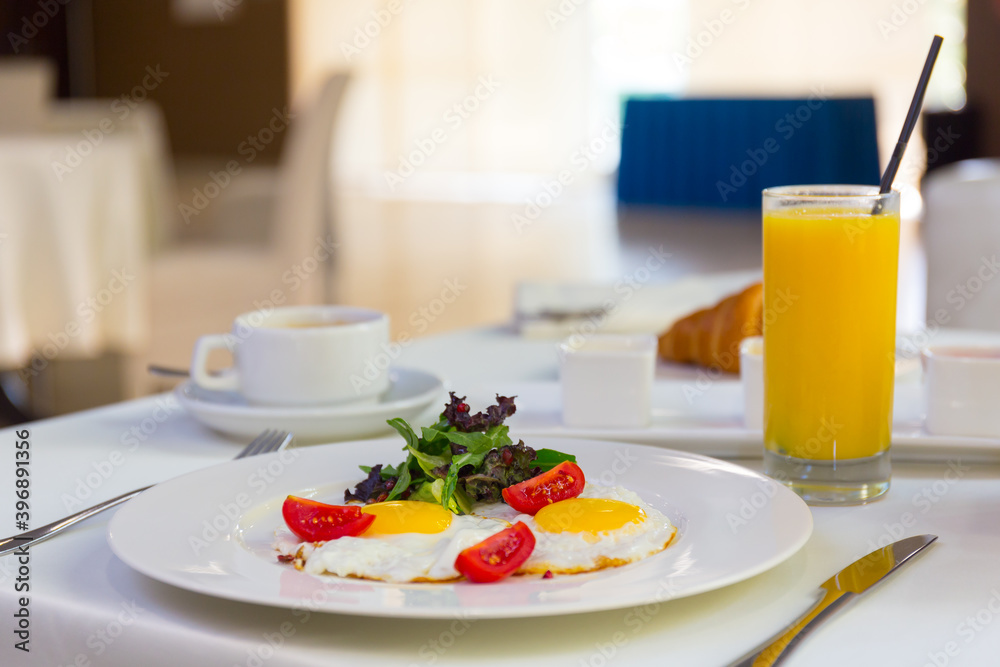 Tasty breakfast with scrambled eggs, juice, croissant and cup of coffe Tasty breakfast with scrambled eggs, juice, croissant and cup of coffe