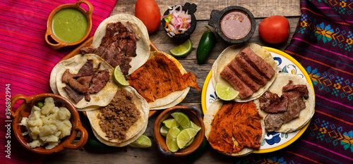 Assortment of mexican tacos on wooden background