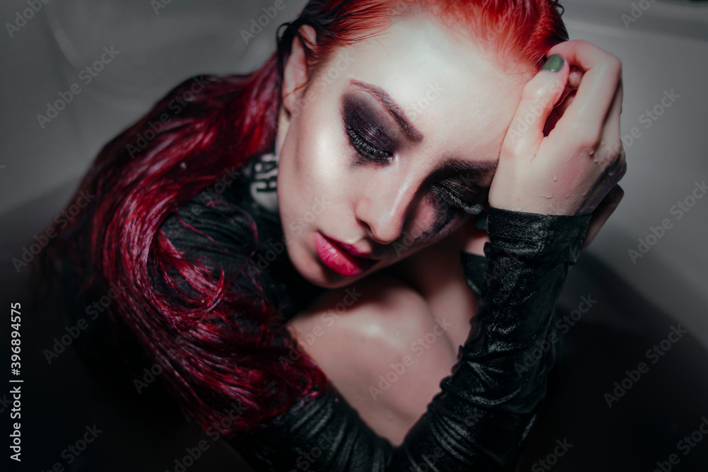 Girl with red hair and black handprints on her face
Girl with red hair and black handprints on her face