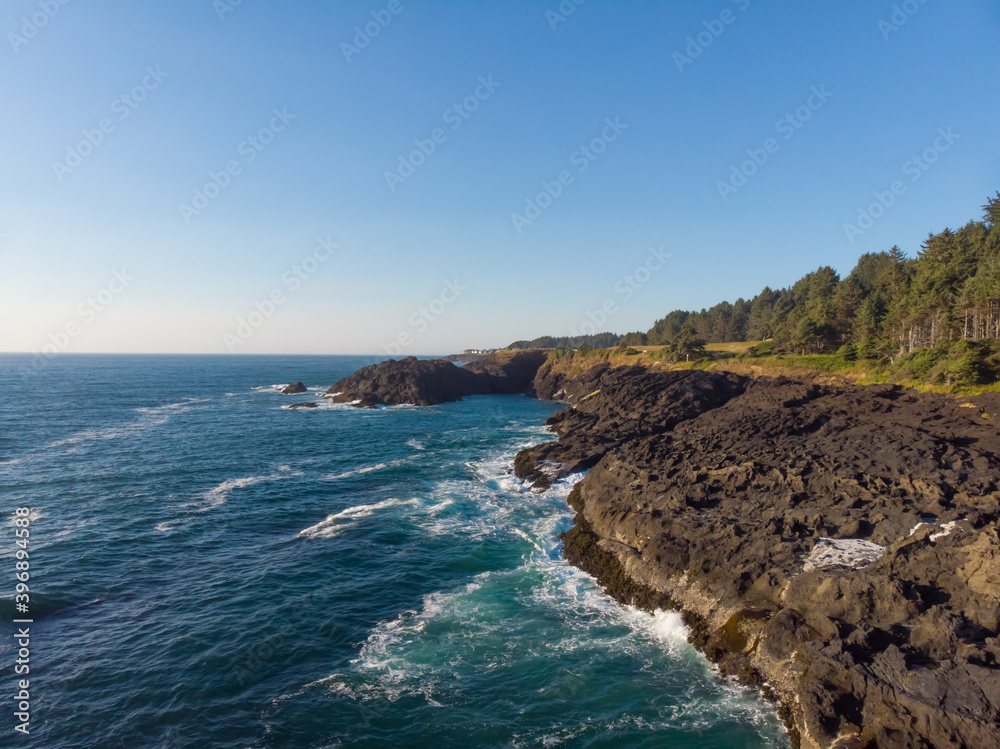 Aerial drone panoramic view of rocky cost in the ocean waves. Beautiful sunny weather. Amazing natural landscape. Wallpaper design.