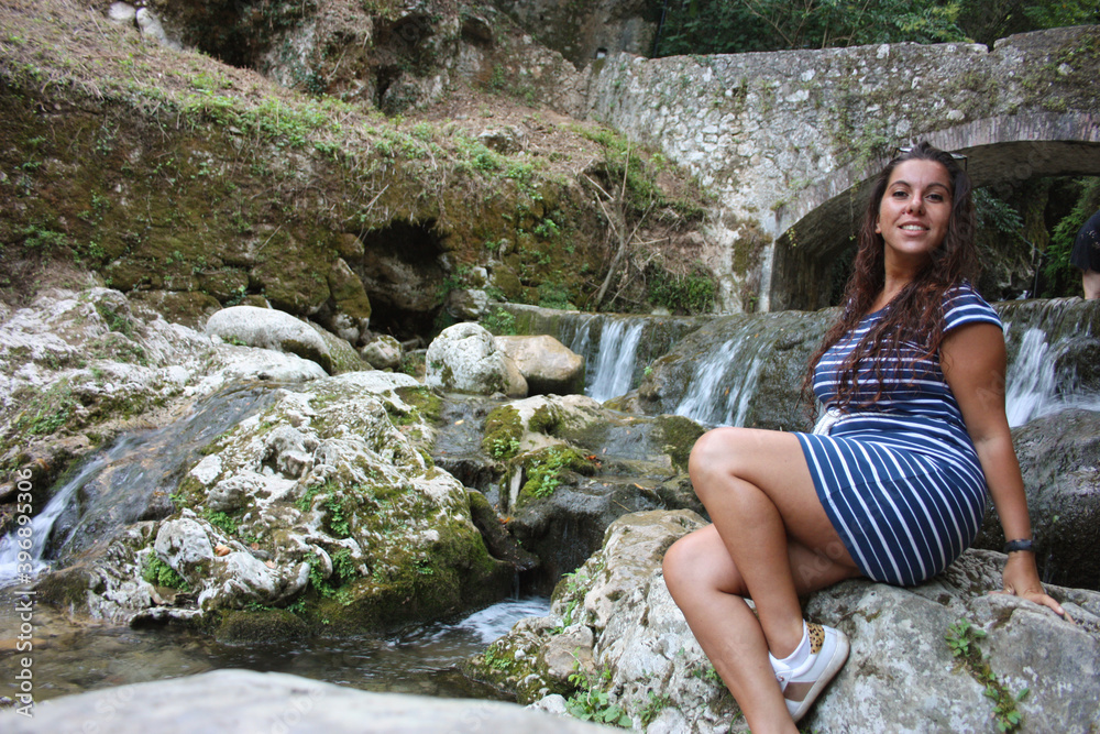 girl summer vacation in the mountains at the river in candalla falls under the rock bridge girl summer vacation in the mountains at the river in candalla falls under the rock bridge