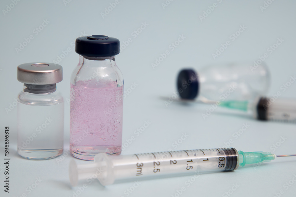 COVID vaccine, Coronavirus vaccine difference dose and size with needle, prepare for injection, medical vaccine on a blude background COVID vaccine, Coronavirus vaccine difference dose and size with needle, prepare for injection, medical vaccine on a blude background
