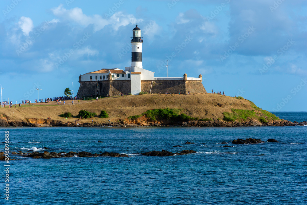 The historic architecture of Salvador in Bahia, Brazil showcasing the Farol da Barra Lighthouse at Bahia de Todos os Santos Bay on a sunny summer day