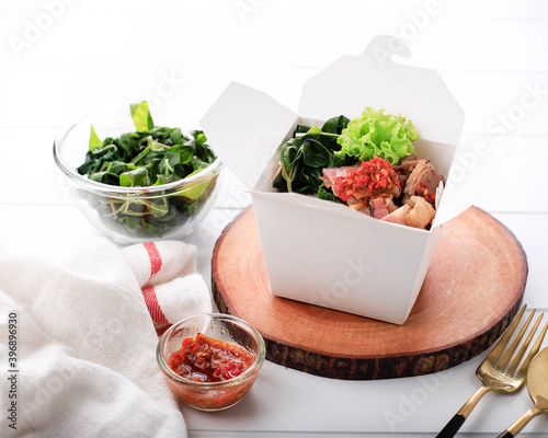 Se'i Sapi or  Beef Sei is Indonesia Traditional Smoked Beef, Served with Boiled Cassava Leaves and Sambal Luat or Sambal Matah. Typically Food from Nusa Tenggara, Indonesia photo