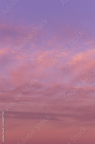 Soft sunrise, sunset pink violet sky with clouds background texture