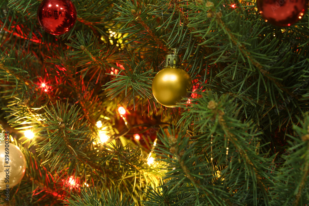 Glowing bright fairy lights and beautiful baubles on Christmas tree