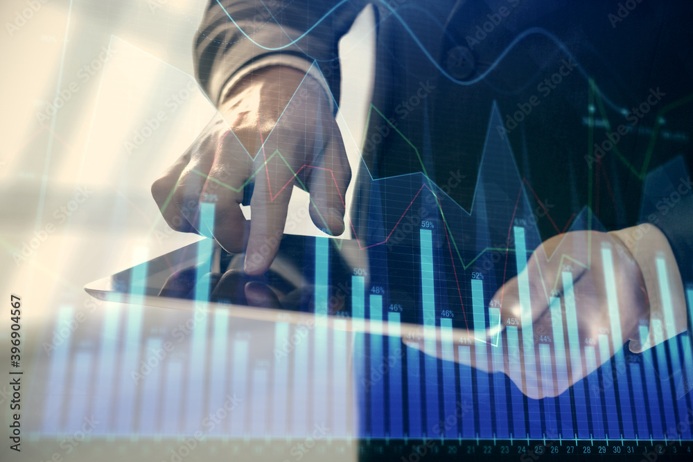 Double exposure of man's hands holding and using a digital device and forex graph drawing. Financial market concept. Double exposure of man's hands holding and using a digital device and forex graph drawing. Financial market concept.