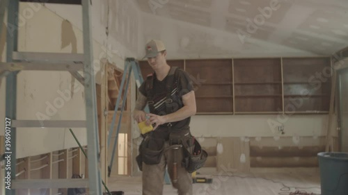 Electrician walks up a ladder to install wires