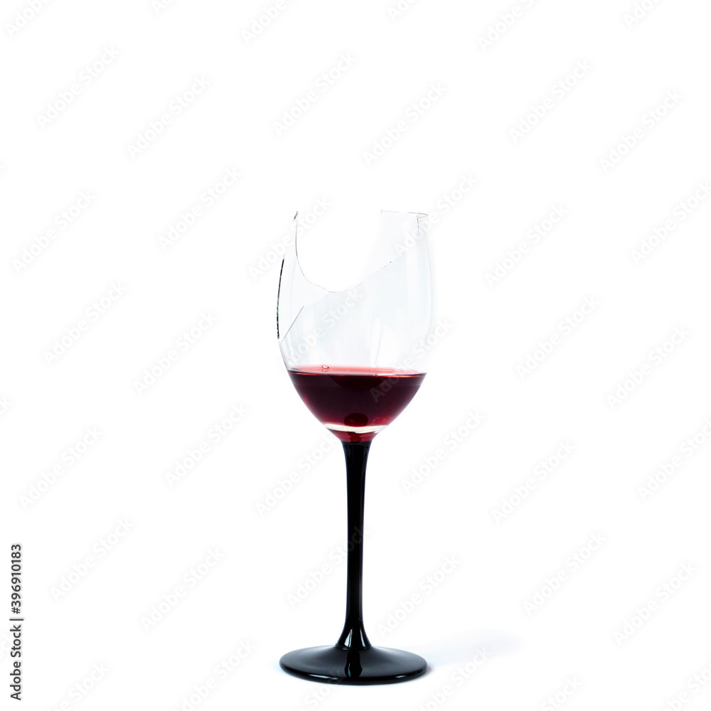 Broken wineglass with remnants of red wine isolated on white background. Broken wineglass with remnants of red wine isolated on white background.