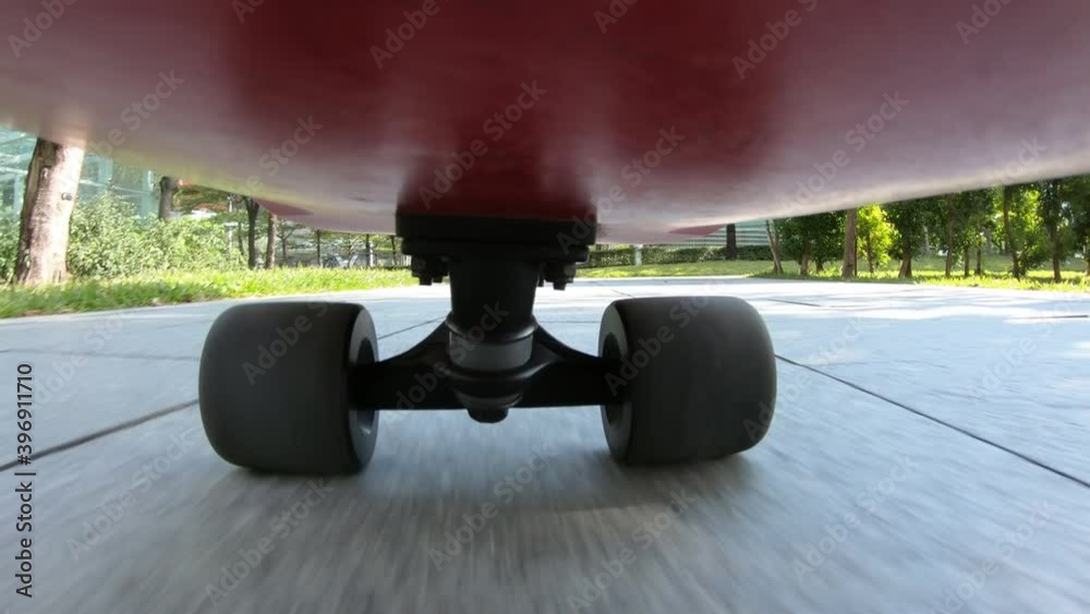 People riding skateboard on street at shenzhen city ,Under skateboard  POV - People skateboarding on road point of view with sound