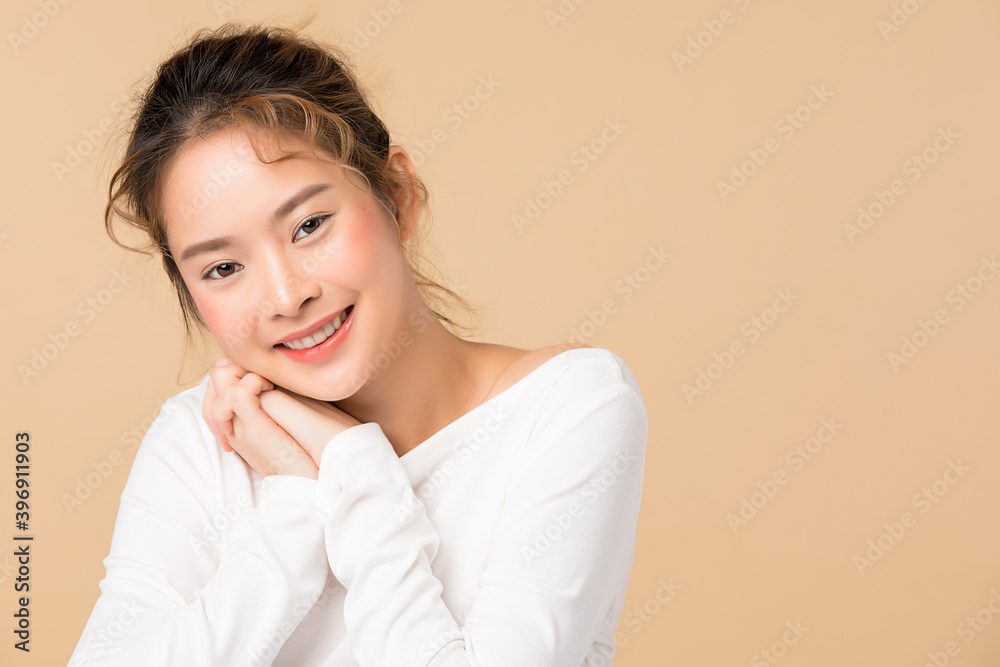 Portrait of young Asian woman smiling isolated on brown background Portrait of young Asian woman smiling isolated on brown background