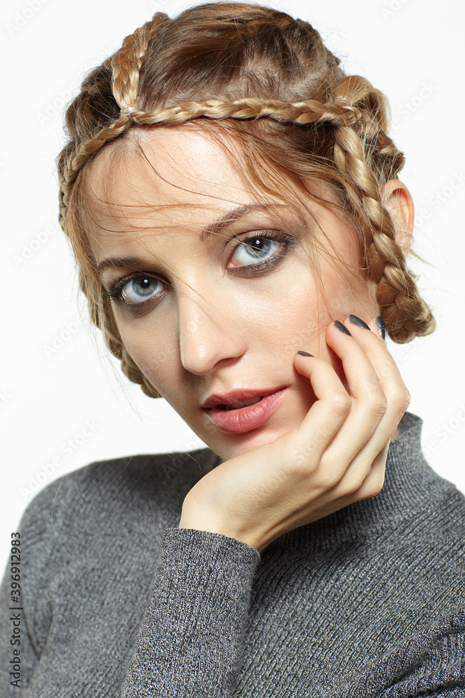 Portrait of blonde female with creative braid hairdo. Portrait of blonde female with creative braid hairdo.