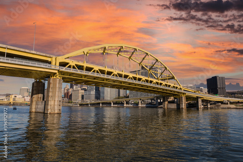Downtown urban waterfront and Route 279 bridge with sunset sky in Pittsburgh, Pennsylvania.