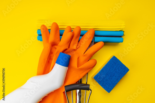 clean concept. set of tools for housework cleaning over orange background. cleaning sponge, sponge mop. copy space. above view