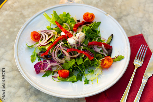 Salad with pearl mozzarella and fresh vegetables closeup