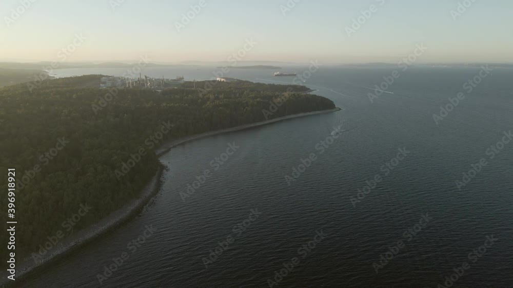 Coastline in Southern Norway, oil refinery and cargo ship in a far. Drone footage Coastline in Southern Norway, oil refinery and cargo ship in a far. Drone footage