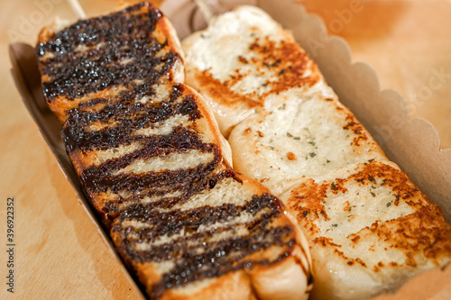 Wallpaper Mural Closeup and crop Garlic Bread and Chocolate Bread on brown recycle plate  background. Torontodigital.ca