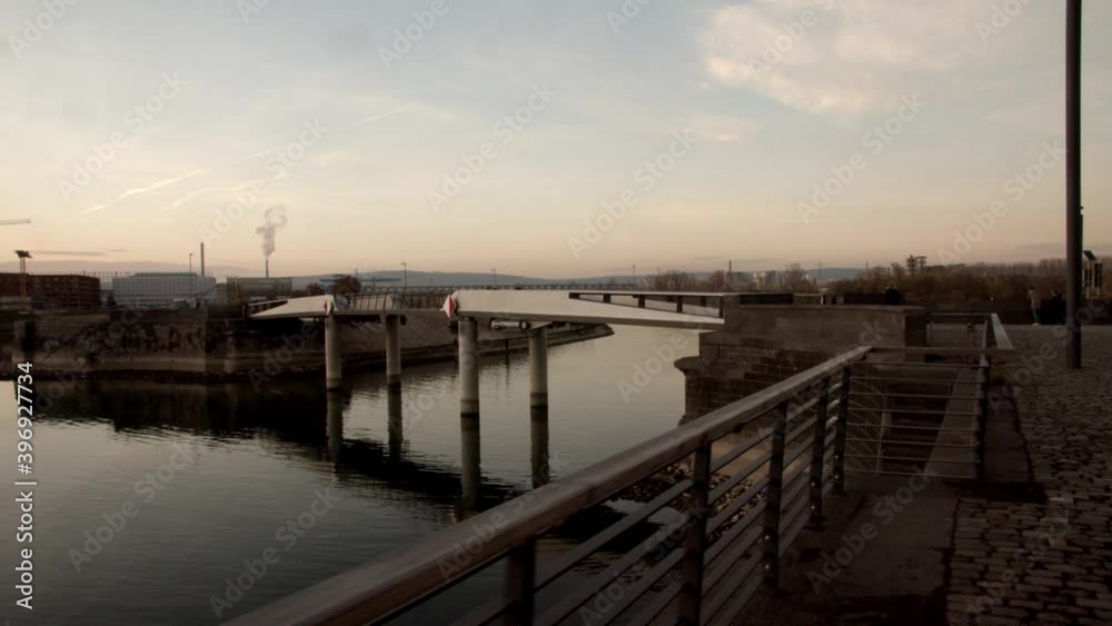 A Bridge at the Customs port in the river rhine in Mainz in a modern urban area during sunset. A Bridge at the Customs port in the river rhine in Mainz in a modern urban area during sunset.