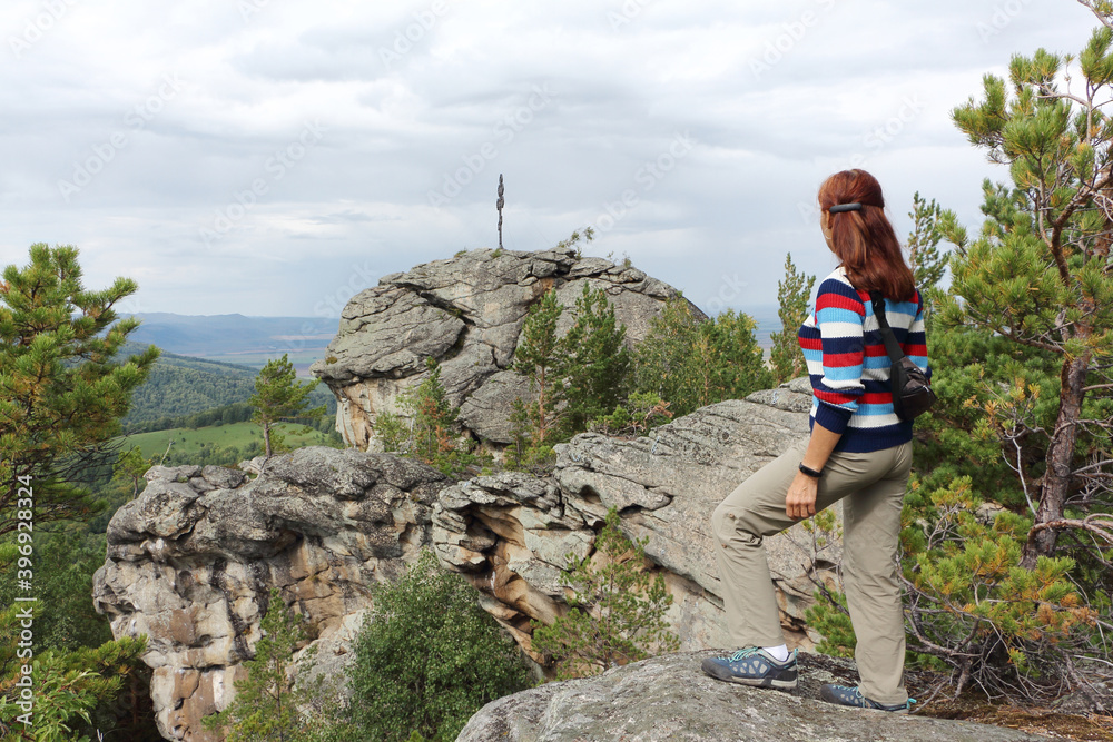 Happy woman standing on the Ambarchiki rock, Belokurikha 2, Altai mountains Happy woman standing on the Ambarchiki rock, Belokurikha 2, Altai mountains