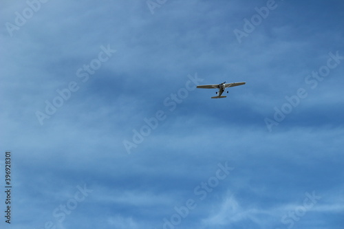 Airplane In The Blue Sky With Clouds