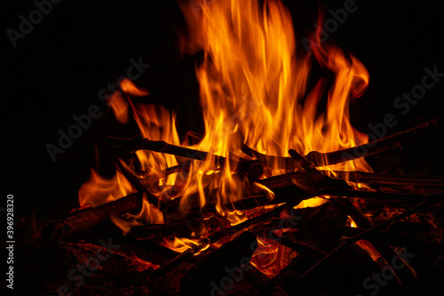 Campfire close up at night with black background. Fire heat adventure camping concept