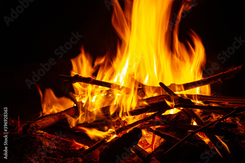 Campfire close up at night with black background. Fire heat adventure camping concept