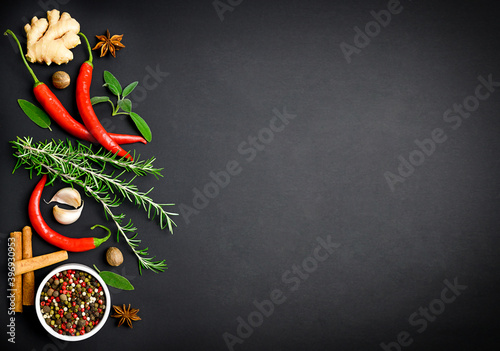 Various spices in spoon, chilli, garlic, copy space, black background