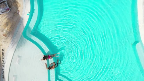 A top down view of a couple talking by the pool side. photo