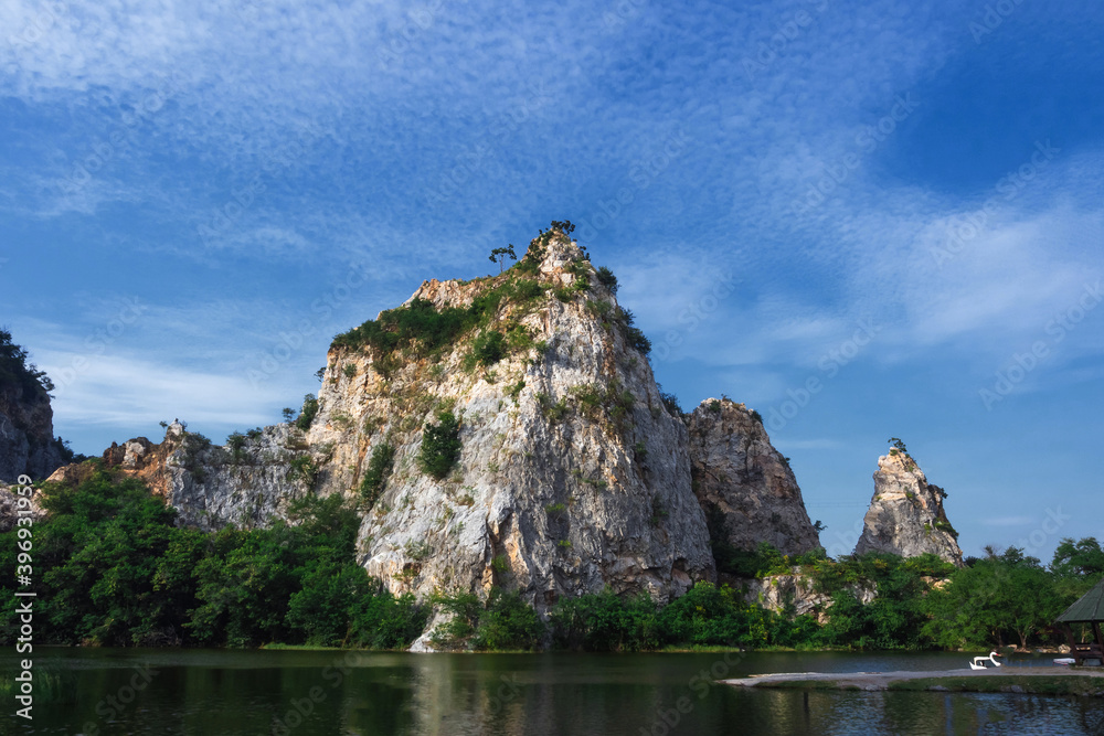 Khao Ngu Stone,Stone mountain with blue sky and lake in front.