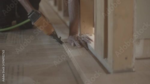 Nail gun against hardwood floors for construction