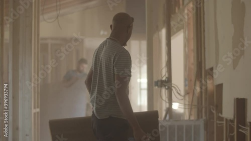 Man stands and walks through a hazey construction site photo