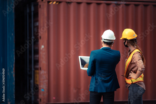 Businessmen, executives and engineers wear medical face masks. While inspecting industrial plants and warehouses for international shipping businesses Concepts of import and export