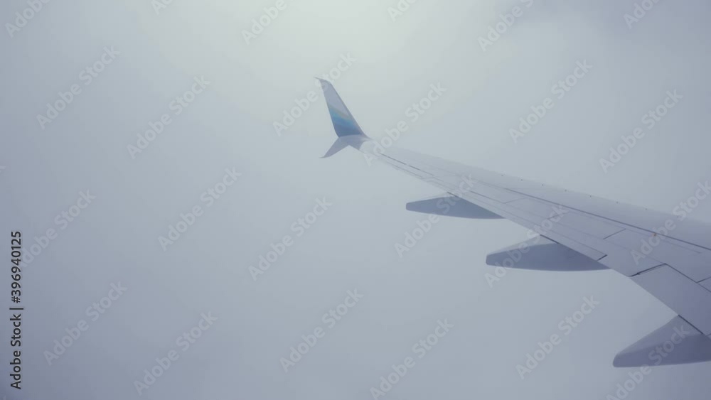 Airplane Landing in Kona, Hawaii. From a passenger window view of the aircraft wing. The plane takes its flight path over the ocean and landing on the Hawaiian Islands in a beautiful 4K time-lapse.