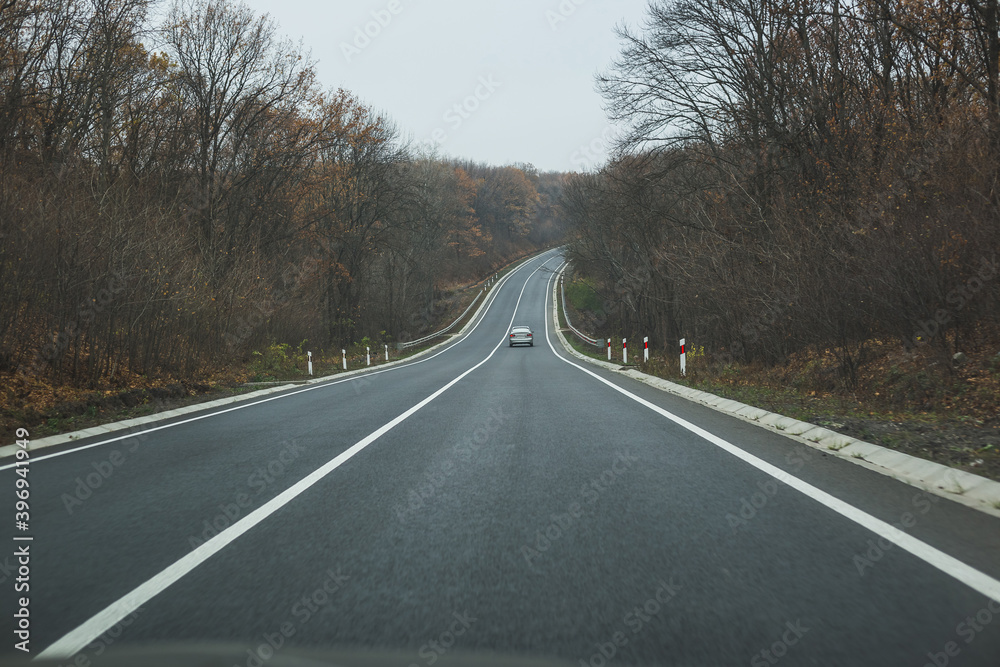 Fototapeta premium Autumn road landscape. View from the car.