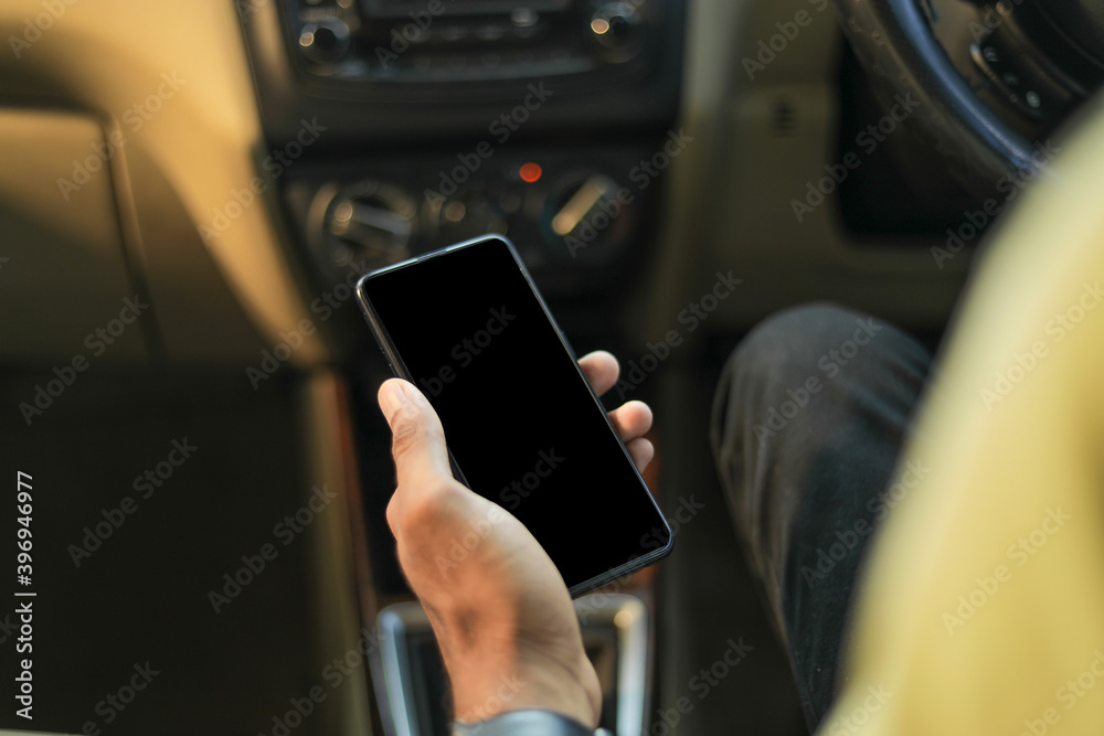 male hand holding mobile phone in car male hand holding mobile phone in car