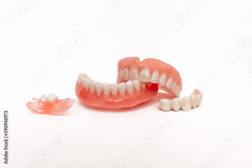Dentures on a white background. Close-up of dentures. Full removable plastic denture of the jaws. Prosthetic dentistry. False teeth. Close-up of plastic denture teeth isolate no fond background
