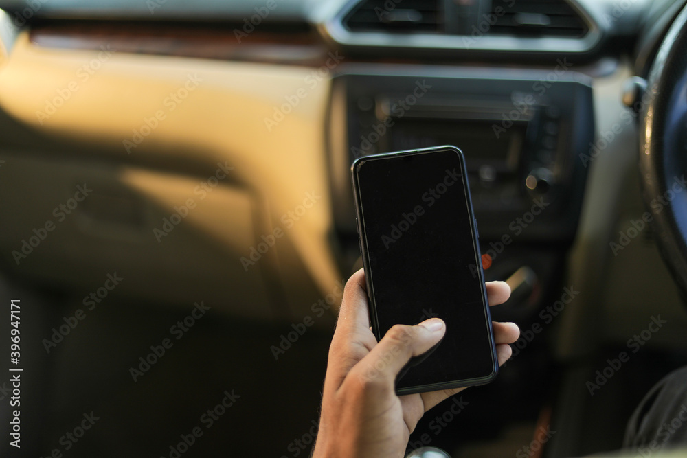 male hand holding mobile phone in car male hand holding mobile phone in car