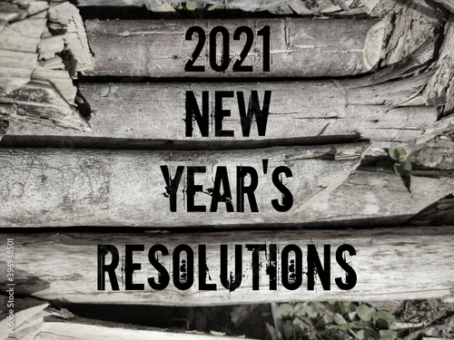 New year concept - text of 2021 NEW YEAR'S RESOLUTIONS on wood background. Stock photo.