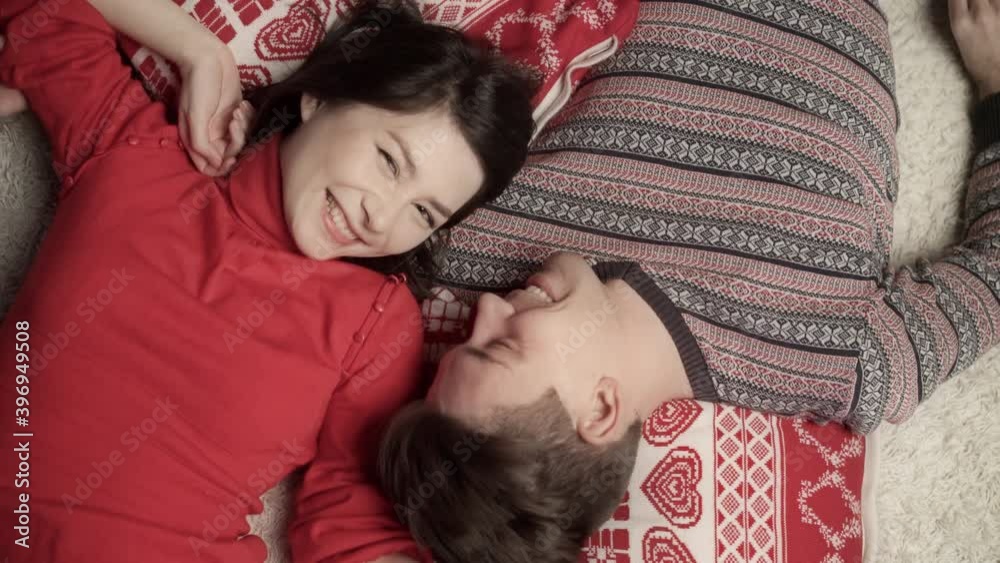 Cute couple in love enjoying xmas and lying head to head. Top view. Relationship, family, christmas, new year, holiday concet.